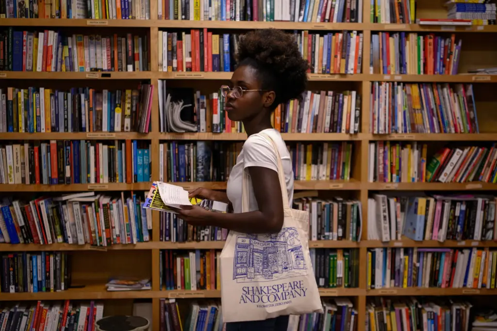 Leslie Gnokoro, 22, of Austin, looks through a library of approved books at Inside Project Books at the Vesper in East Austin on May 21.
