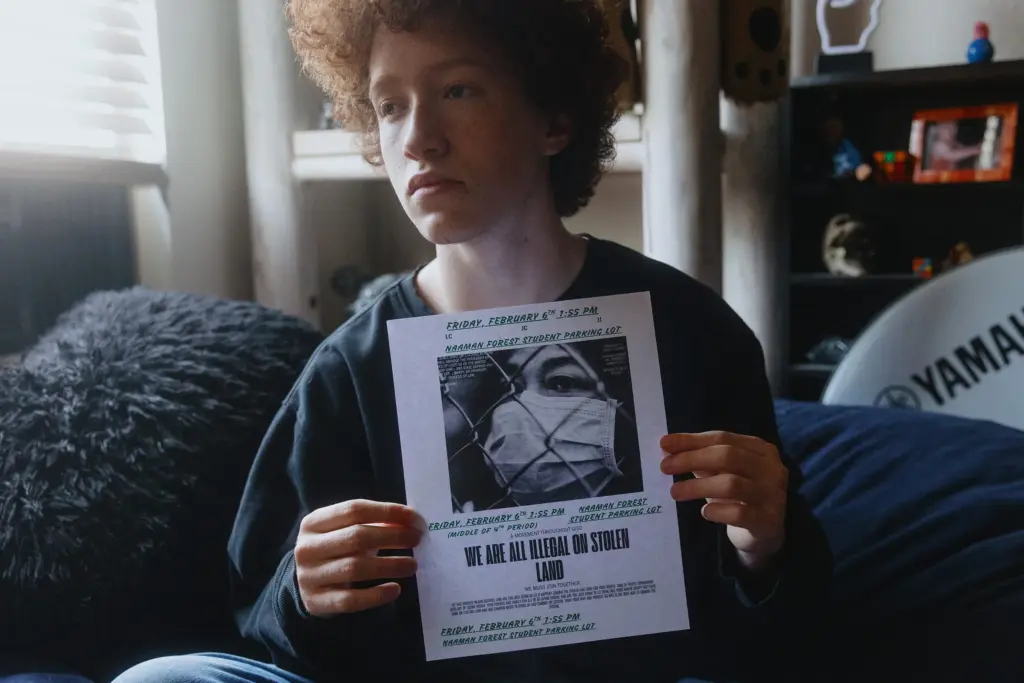 Jordan Comfort, a high school junior, holds the flyer he handed out that led to his assignment to a DAEP in Garland, Texas. Students all over North Texas were planning a walkout to protest Immigration and Customs Enforcement, and Comfort was one of several students handing out flyers for the one at his school in Garland.
