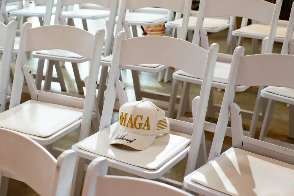 Texas businessman B. R. Israel’s MAGA hat, signed by President Donald Trump during a visit to Mara-Lago, sits on a chair before Paxton’s campaign event in Dripping Springs on Thursday.