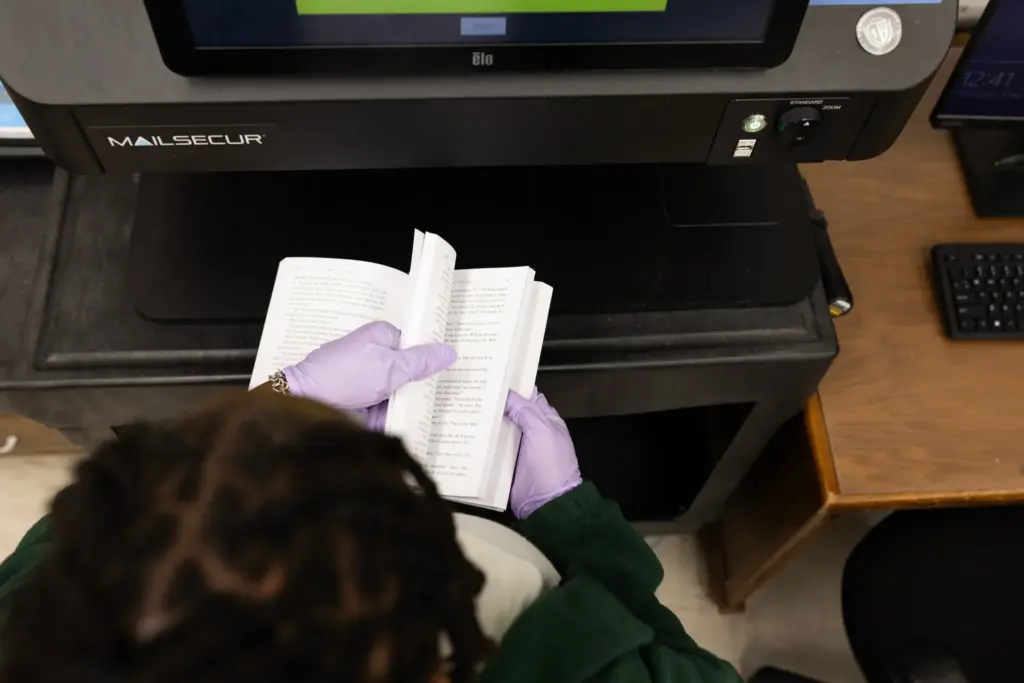 SLIDESHOW: TDCJ administrative assistant Alexis Page scans books in the mail room at the Wynne Unit in Huntsville to look for possible contraband.