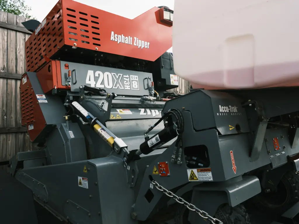 Wallingsford explained: “That is what our guys do probably eight months out of the year. They use this zipper machine here to eat up the old asphalt. Then we compact it with a rolling machine over there, and then we come back and chip seal the existing roads. It’s a cheaper way of getting the potholes out of the roads and giving the citizens a smoother surface to drive on.” The equipment was purchased in a bond election to save the city money by paying outside contractors to repave the city’s streets. Previously the maintenance department was only able to fill potholes.