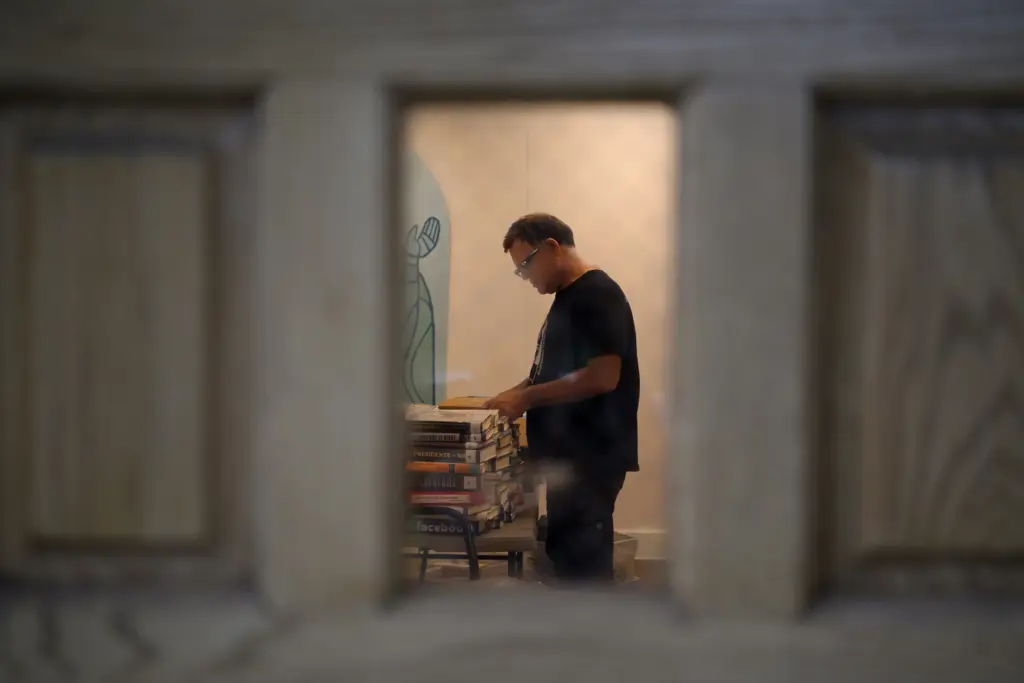 Inside Book Project coordinator Scott Odierno, 55, sorts through donated books to determine if they are banned in Texas prisons .