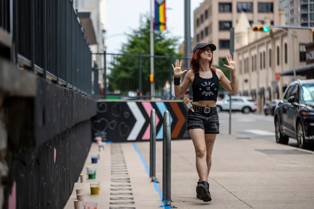 An attendee dances along the nearly installed mural on 4th street on June 20, 2026 in downtown Austin.