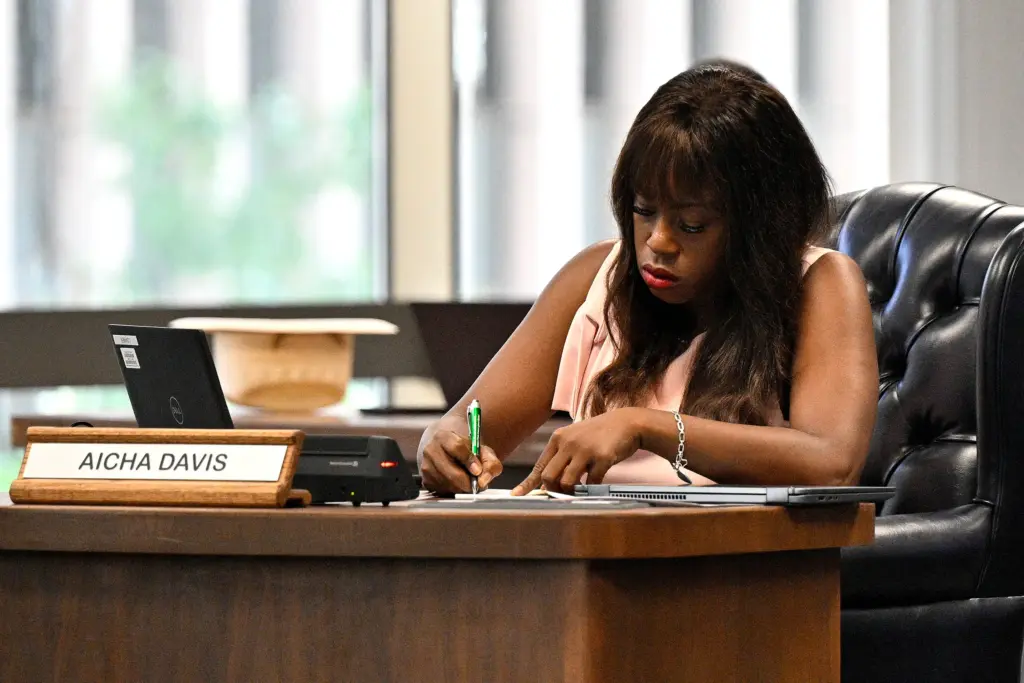 Then-State Board of Education member Aicha Davis takes notes during an SBOE meeting in Austin on June 26, 2024.