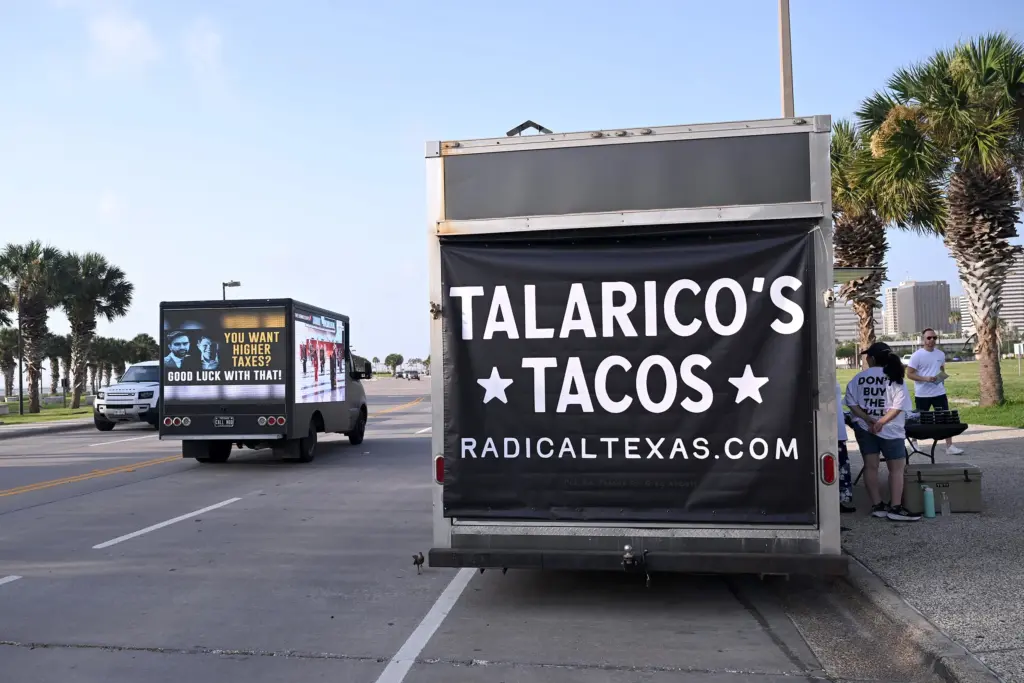 Volunteers with the Republican group Radical Texas pushed their message outside the convention by handing out free