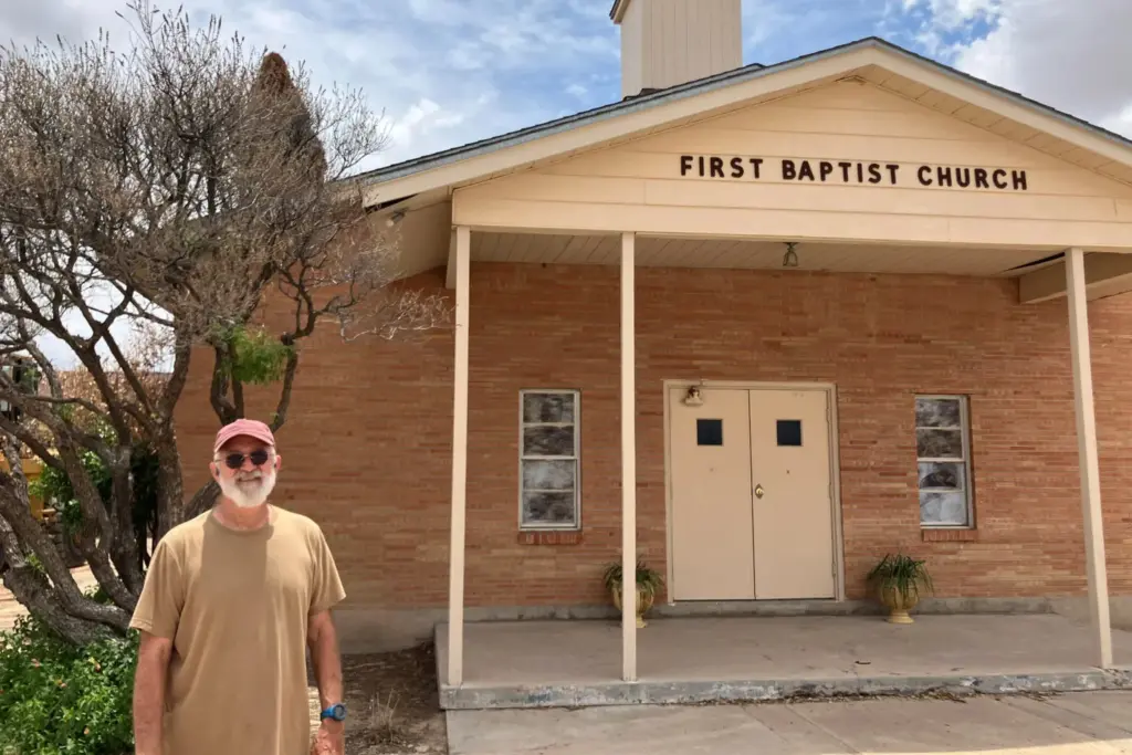 Pastor David Tucker stands outside the First Baptist Church of Grandfalls. Tucker stepped in as pastor at the church last summer in addition to his full-time job in the oil and gas industry.