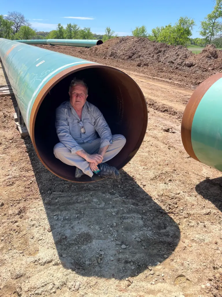 Ty Eggemeyer sits in a pipeline to offer a sense of its size.