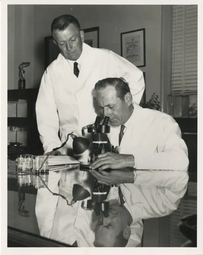 Taken in the 1950s, this photo shows Dr. Edward F. Knipling (seated) and Dr. Raymond C. Bushland in a laboratory.