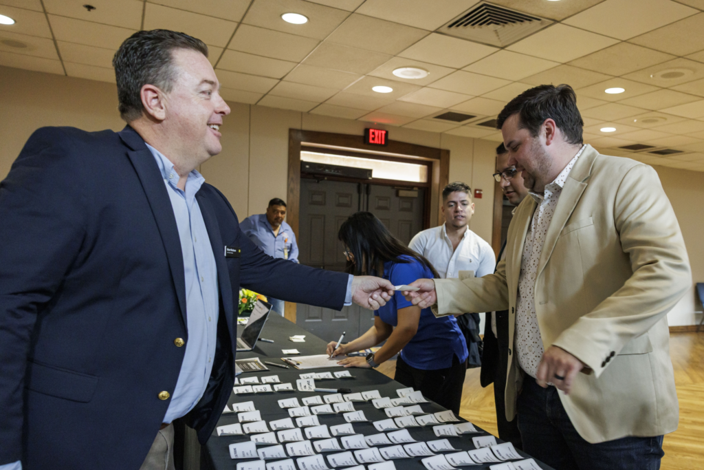 Tribune VP of Sales Robert Nusbaum chats with an attendee before the start of a Sept. 25, 2025 event in Brownsville on preparing the next generation of RGV workers.