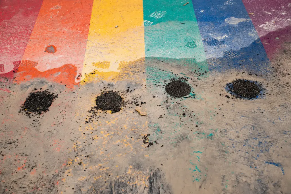 The rainbow crosswalk at North Main Avenue and West Evergreen Street is scrubbed away on Jan. 12, 2026 in San Antonio, Texas. The City of San Antonio is preserving pieces of the rainbow colors in the crosswalk for possible future art installations.