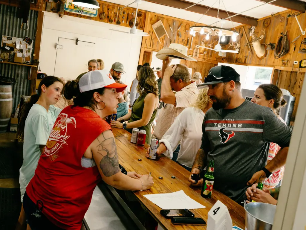 Community members fill Crider's Rodeo & Dancehall on a Friday evening for the weekly fish fry in Hunt, Texas on June 12, 2026.