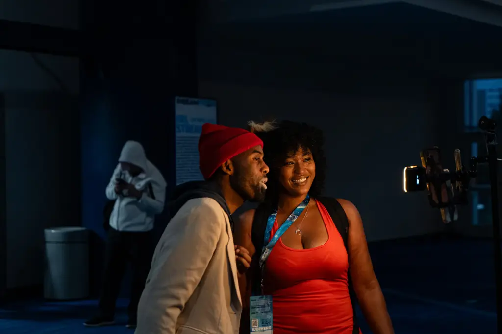 Two Dream Con 2026 attendees stop to live stream content during the three day pop culture, tech, film and gaming event, where social media and tech was on full display . Saturday, July 11, 2026, in Houston. (Douglas Sweet Jr / The Texas Tribune)