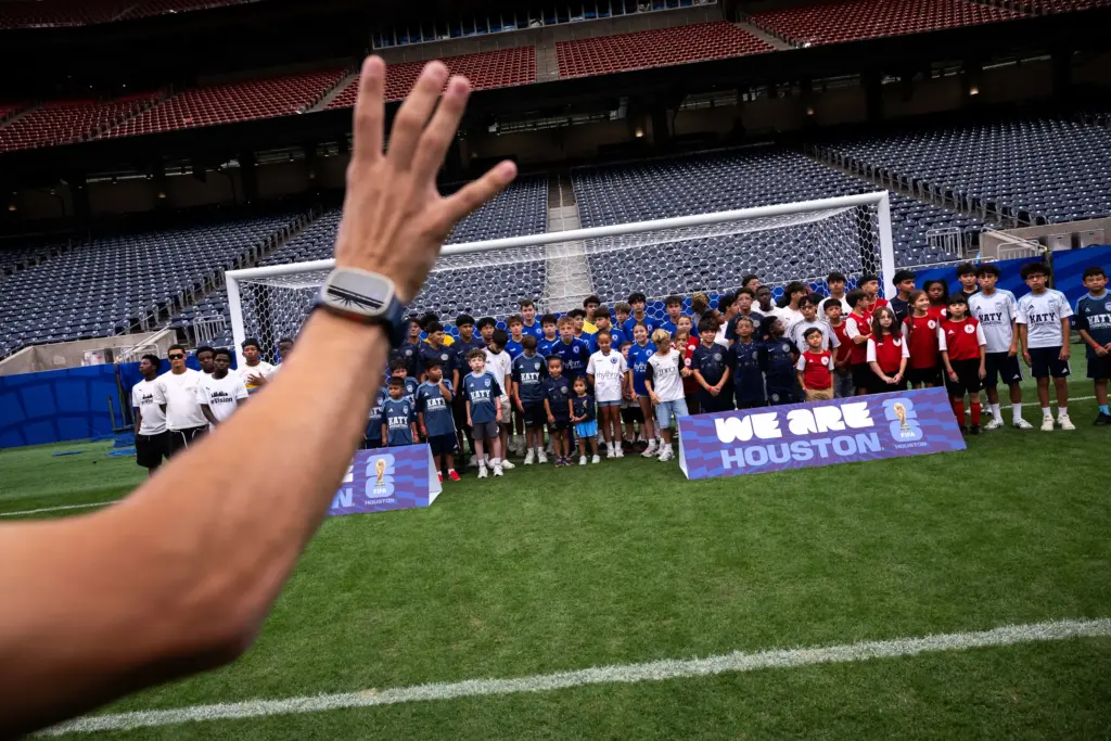 The Houston reVision team take a group photo alongside other Houston area soccer clubs while they take a tour of the World Cup stadium, Sunday, July 5, 2026, in Houston.