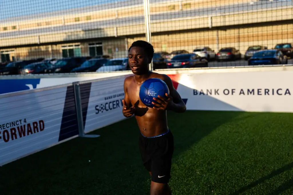 Moises Badera plays soccer with his friends in late June on a Houston reVision pitch, which is on the site of a former juvenile corrections facility in Houston.