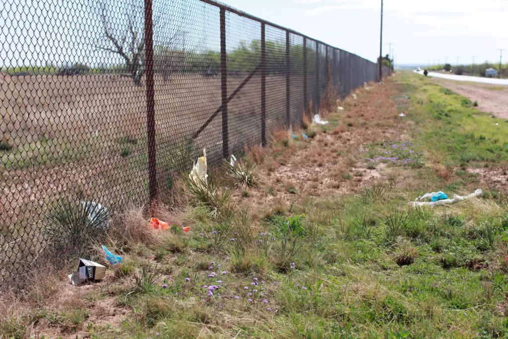 Six packs, boot covers and other construction debris litter the fenceline on the road leading to the data center. “There's trash all over the place,” local resident Omaira Garcia told Floodlight.
