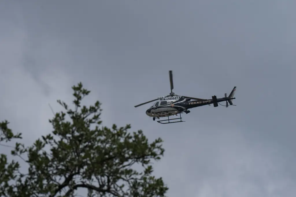 A Texas Department of Public helicopter flies over Uvalde on July 15, 2026, as floodwaters rise across the city.