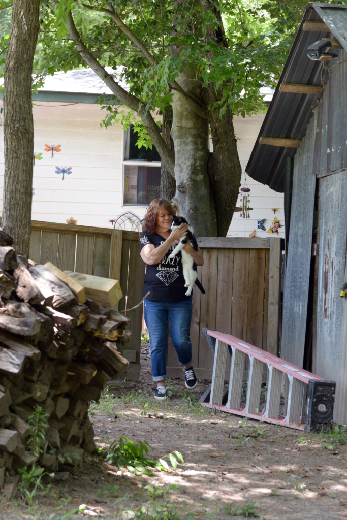 Kaesha Avishai with one of her cats at her home near Lufkin.