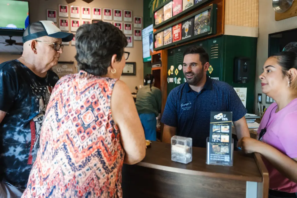 Owner of George’s Restaurant Kyle Citrano greets a couple from Florida in Waco, TX on June 25, 2026.