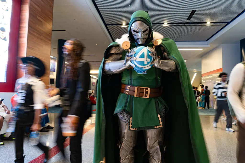 A Dr. Doom cosplayer poses while the crowds of attendees make their way through the halls of the George R. Brown Convention Center during the 2026 Dream Con, a three day event for pop culture, tech and film, in Houston. Saturday, July 11, 2026, in Houston. (Douglas Sweet Jr / The Texas Tribune)