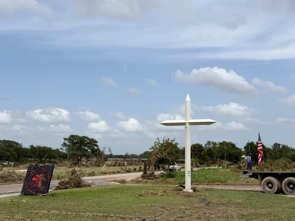 A memorial dedicated to those who died in the Kerr County floods last year stands in front of the Center Point Volunteer Fire Department on July 17, 2026. Twenty-four hours prior, the area was largely underwater.