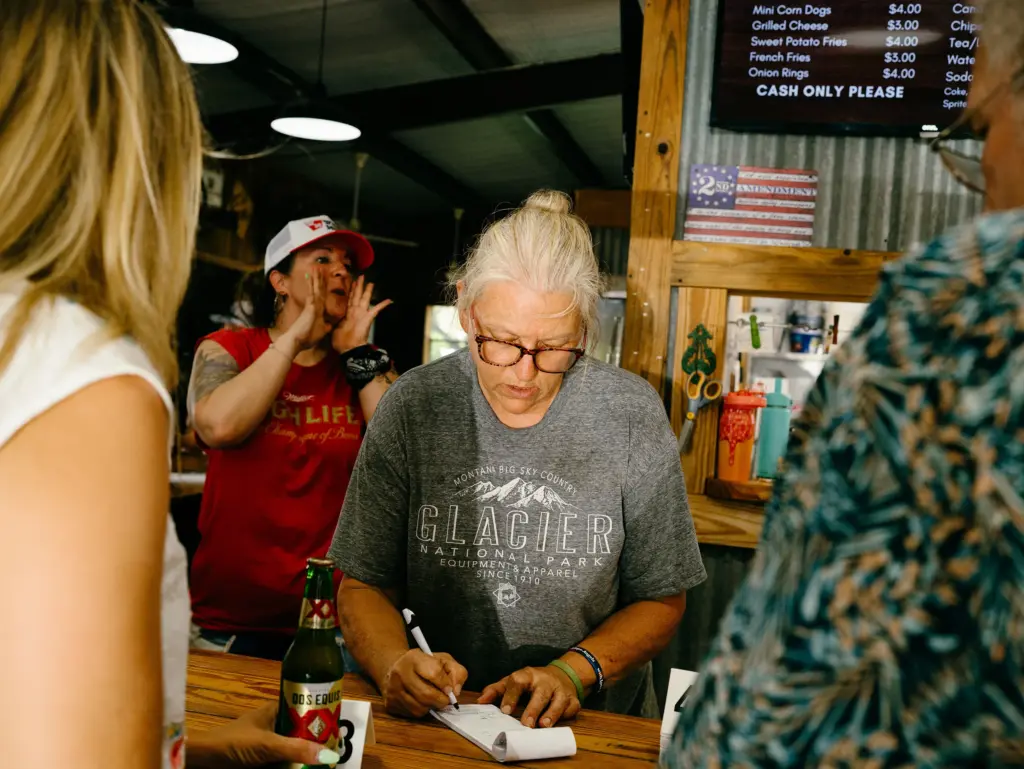 Tracy Moore takers order at Crider's Rodeo & Dancehall in Hunt, Texas on June 12, 2026.