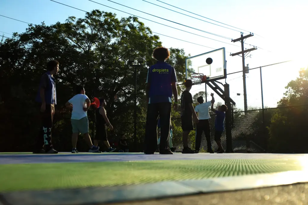 Children play basketball outside as a conference takes place inside at the North Austin Muslim Community Center-Masjid Aisha.