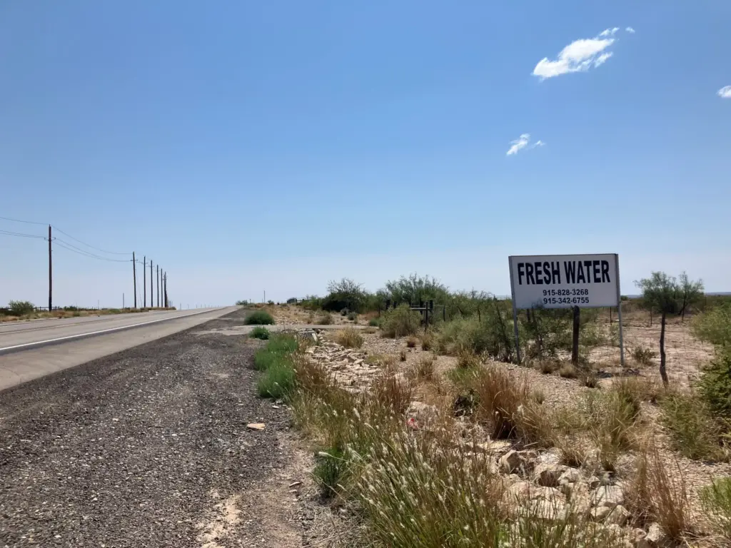 A sign on the side of the highway in the Permian Basin advertises fresh water for sale. Fracking requires significant volumes of water to complete wells.