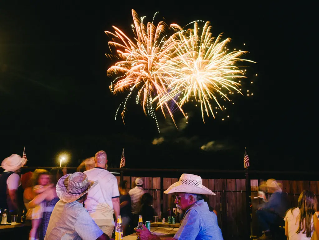 People watch the fireworks at Crider’s Rodeo and Dance Hall on the Fourth of July, 2026 in Hunt, Texas. A year ago, a devastating flood took the lives of 119 people in Kerr County.