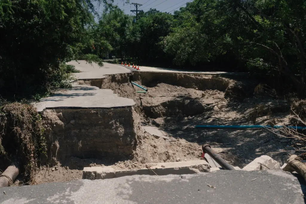 Badly damaged patch of road on the Arcadia Loop in Kerrville .