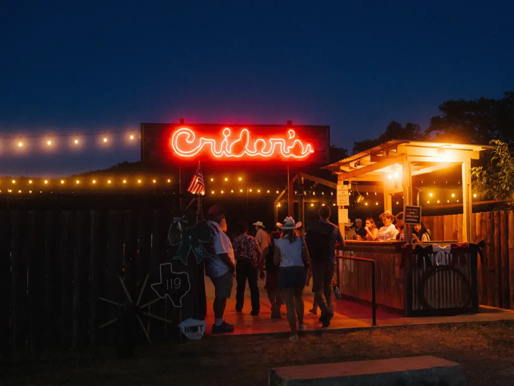 People arrive at Crider’s Rodeo and Dance Hall to celebrate the Fourth of July in Hunt, Texas on July 4, 2026. A year ago, a devastating flood took the lives of 119 people in Kerr County.